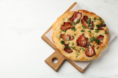 Photo of Delicious focaccia bread with bacon and parsley on white table, top view