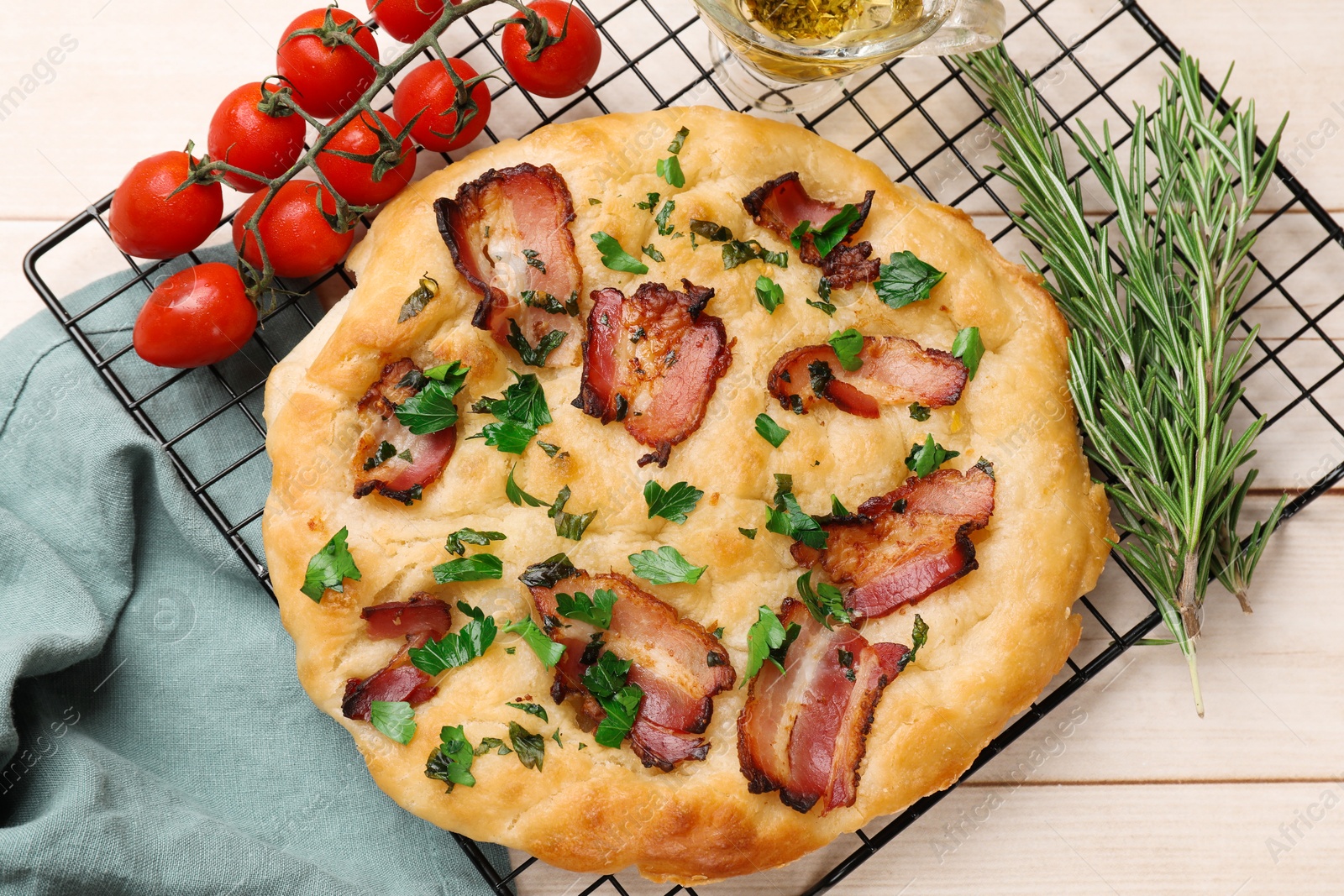 Photo of Delicious focaccia bread with bacon and parsley on white wooden table, flat lay