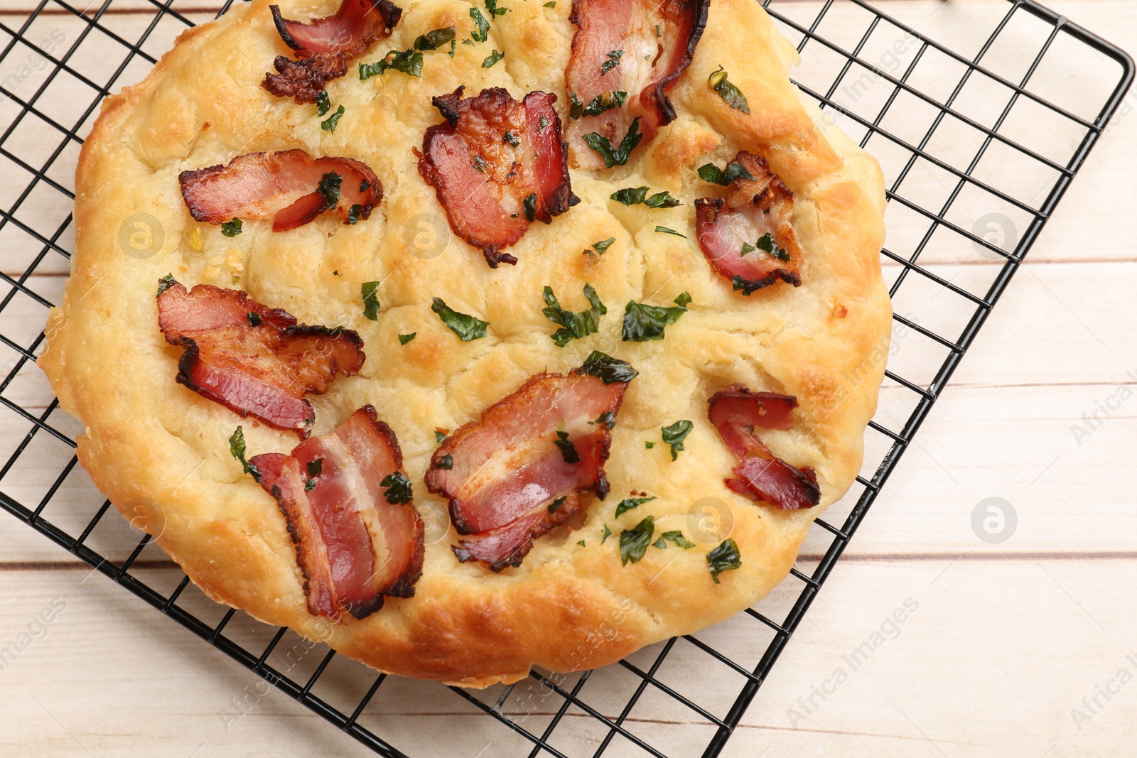 Photo of Delicious focaccia bread with bacon and parsley on white wooden table, top view