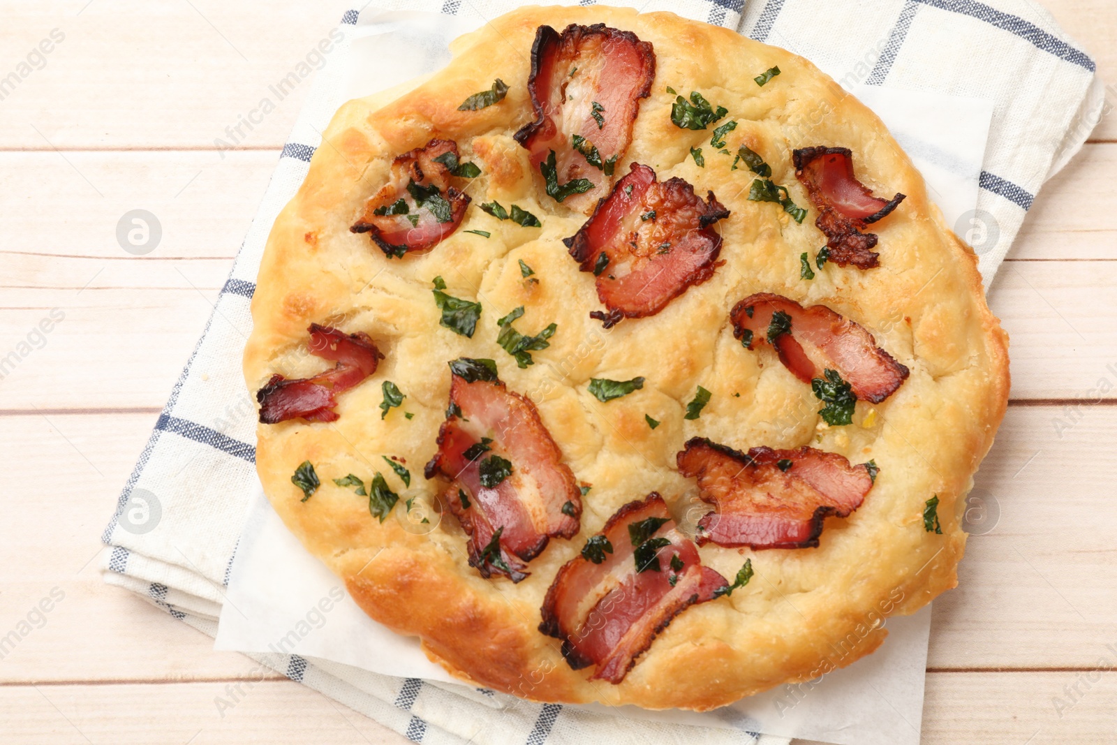 Photo of Delicious focaccia bread with bacon and parsley on white wooden table, top view