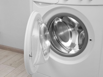 Photo of Washing machine with empty drum indoors, closeup