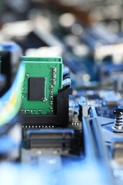 Photo of Computer motherboard with RAM chip as background, closeup. Electronic engineering