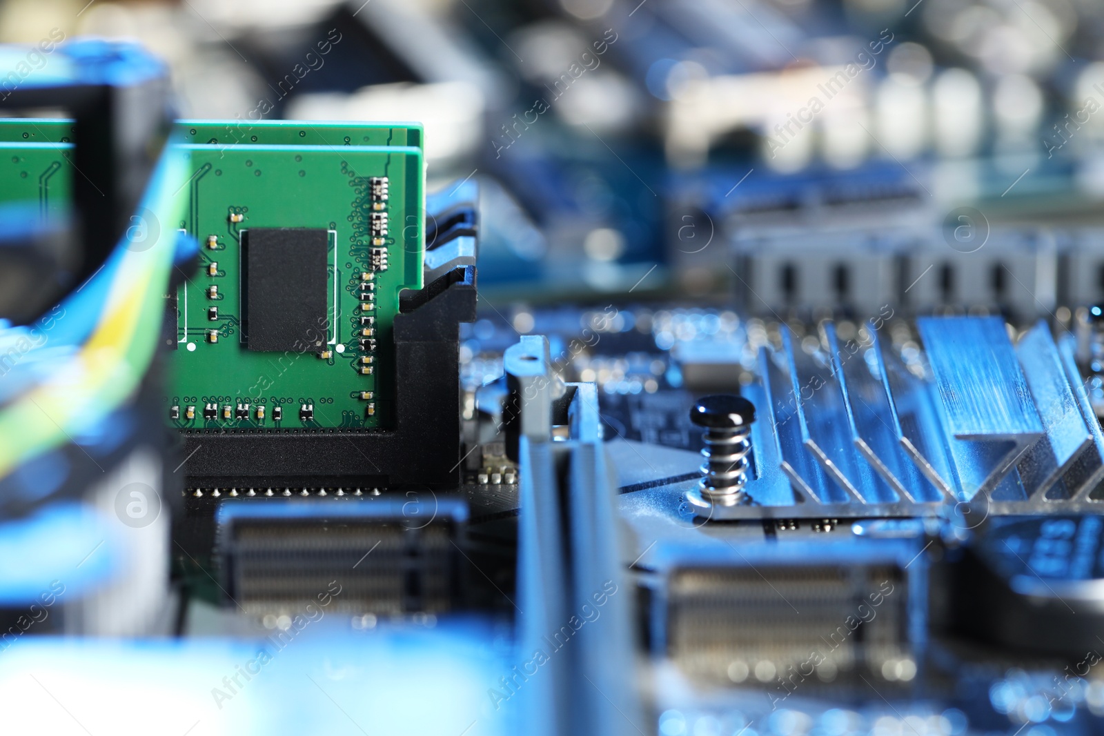 Photo of Computer motherboard with RAM chip as background, closeup. Electronic engineering