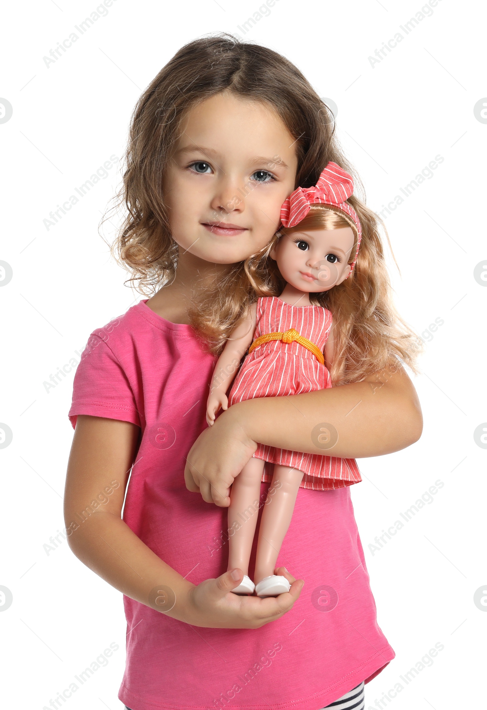 Photo of Cute little girl holding doll on white background