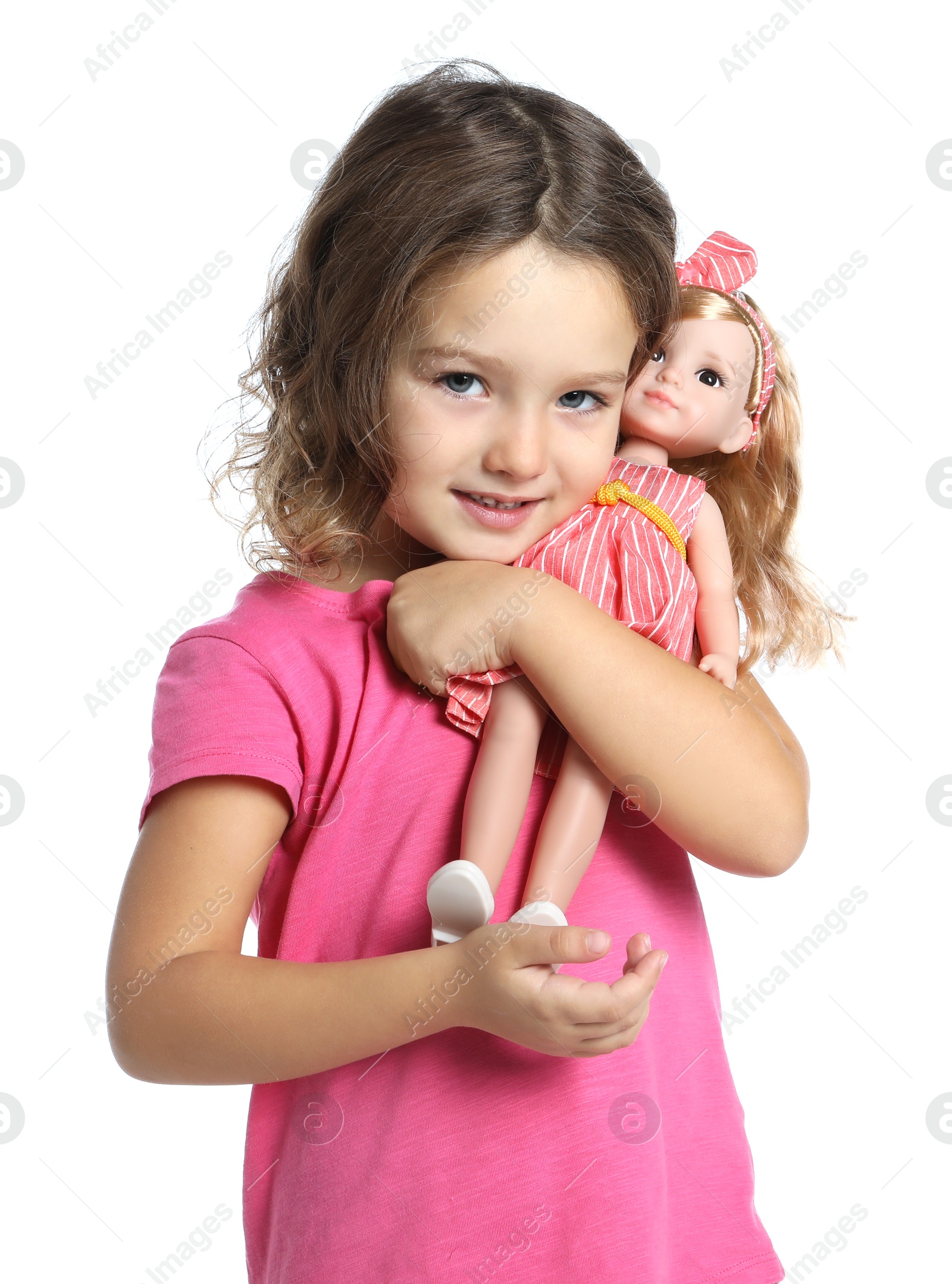 Photo of Cute little girl holding doll on white background