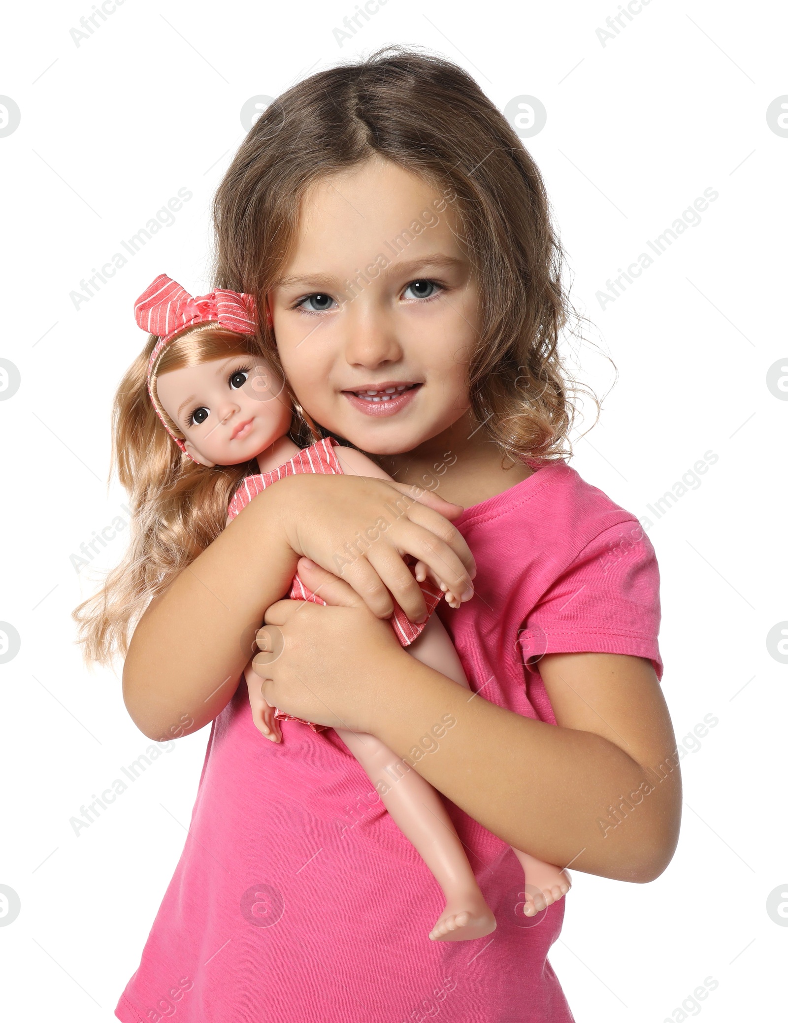 Photo of Cute little girl holding doll on white background