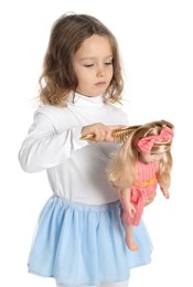 Photo of Cute little girl brushing doll's hair on white background