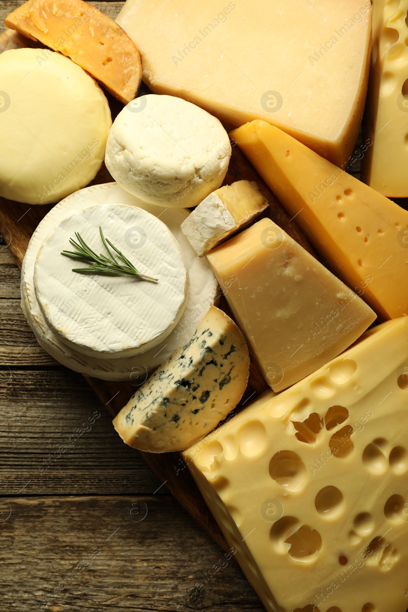 Photo of Different types of cheese on wooden table, top view