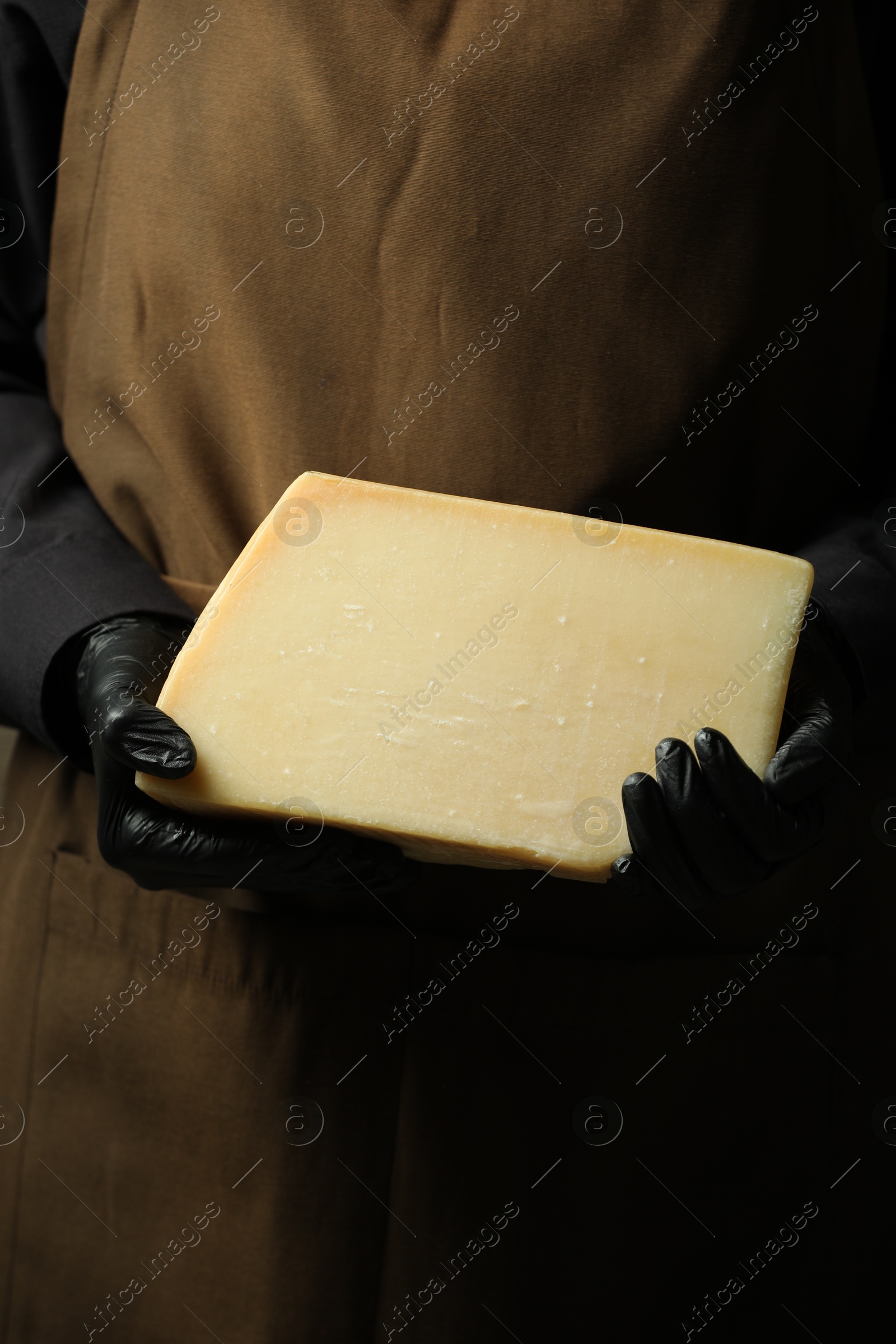 Photo of Woman with piece of delicious cheese, closeup