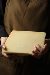 Photo of Woman with piece of delicious cheese, closeup