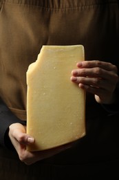 Photo of Woman with piece of delicious cheese, closeup