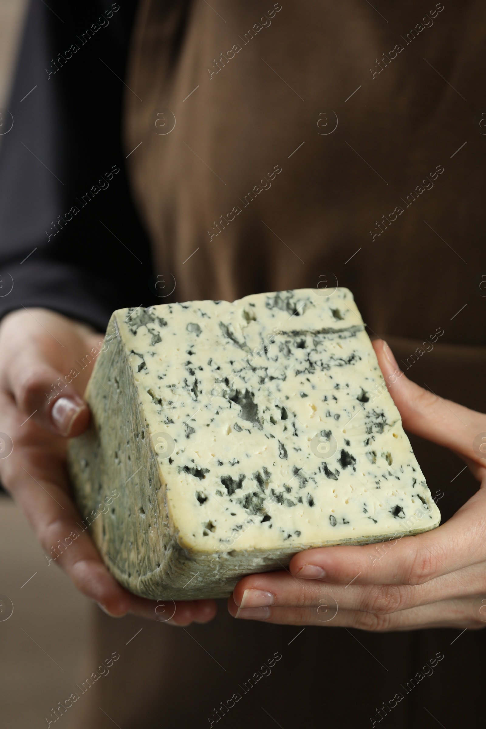 Photo of Woman with piece of delicious cheese, closeup