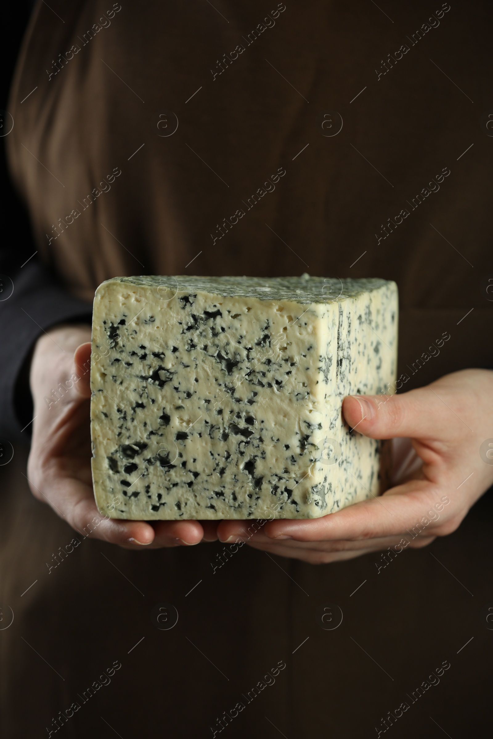 Photo of Woman with piece of delicious cheese, closeup