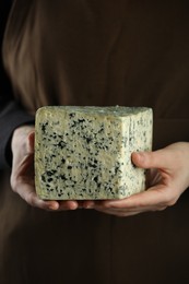 Photo of Woman with piece of delicious cheese, closeup