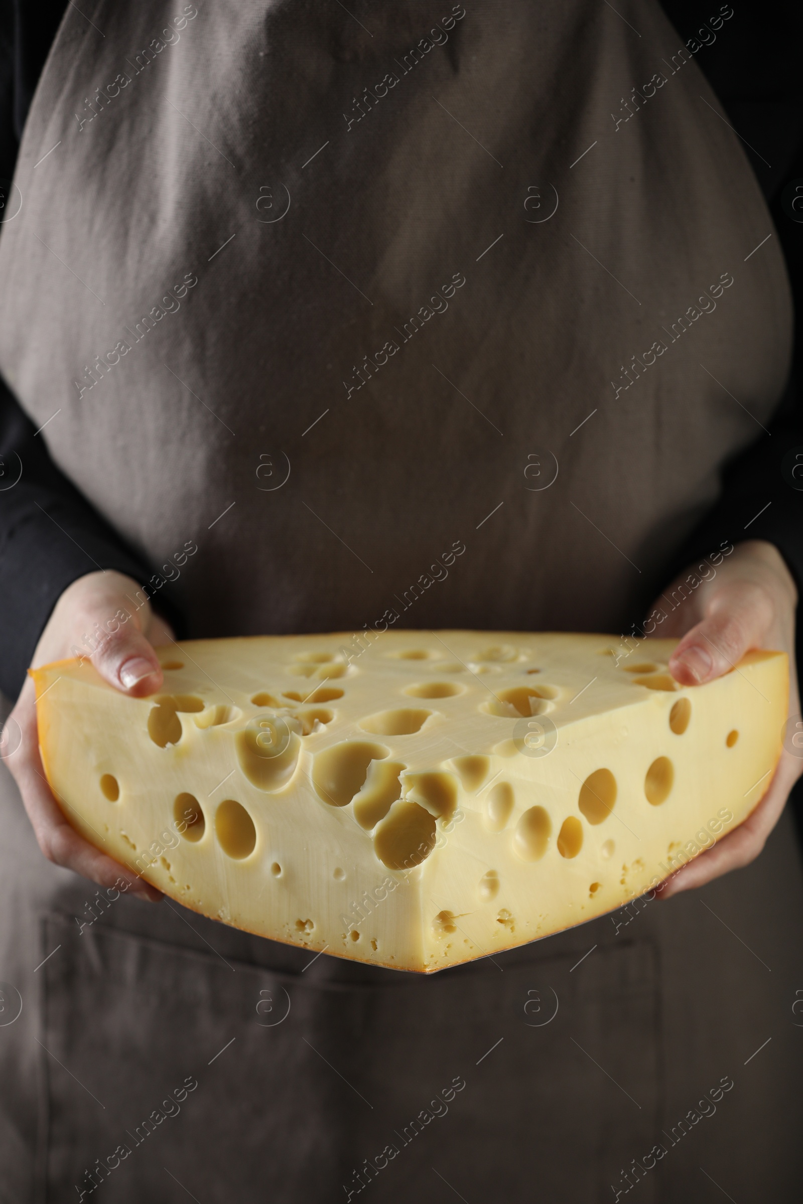 Photo of Woman with piece of delicious cheese, closeup