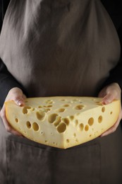 Photo of Woman with piece of delicious cheese, closeup