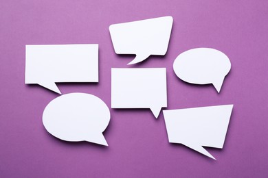 Photo of Blank speech bubbles on purple background. Space for text