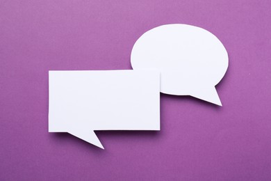 Photo of Blank speech bubbles on purple background. Space for text