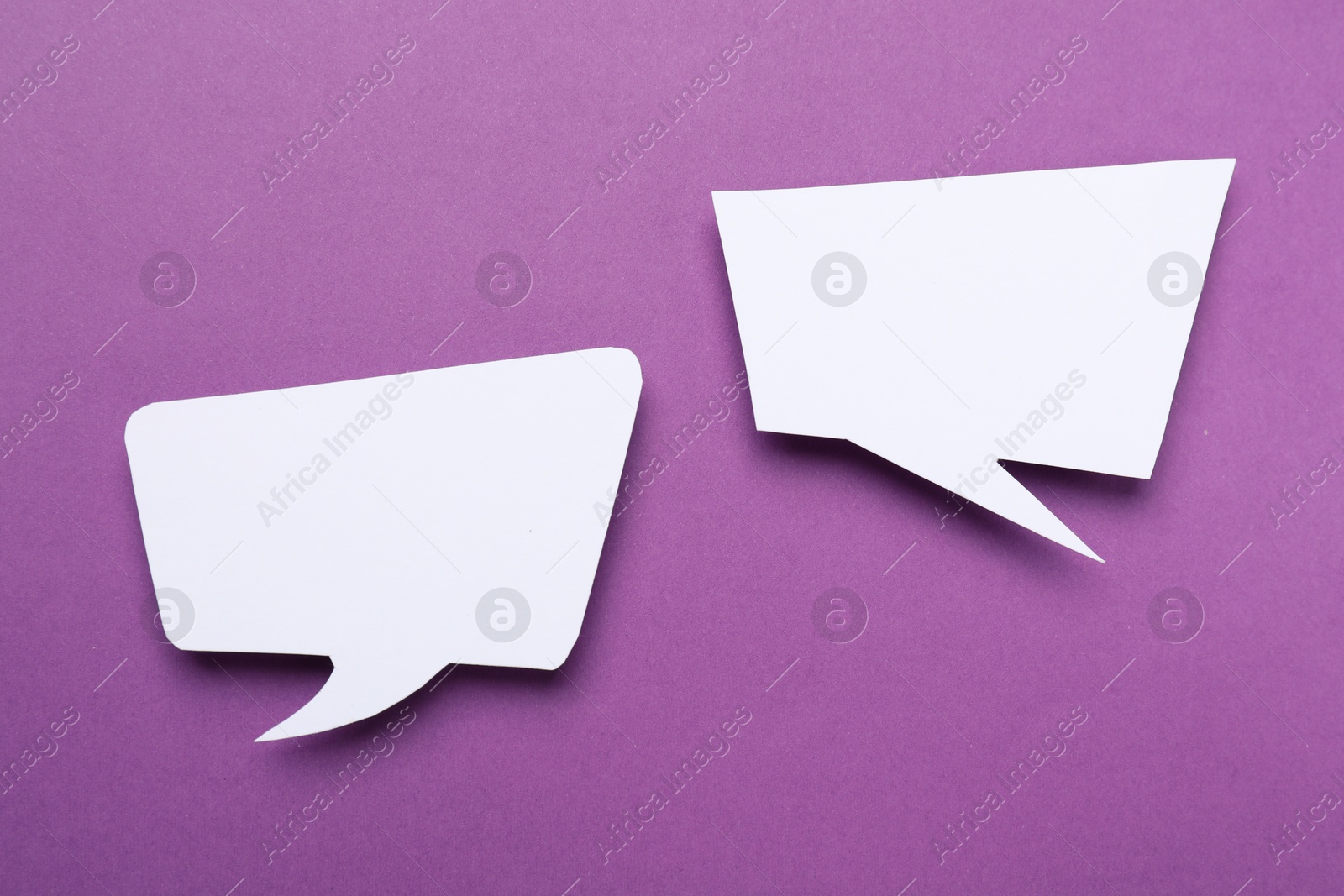 Photo of Blank speech bubbles on purple background. Space for text