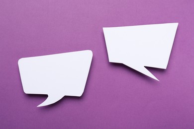 Photo of Blank speech bubbles on purple background. Space for text