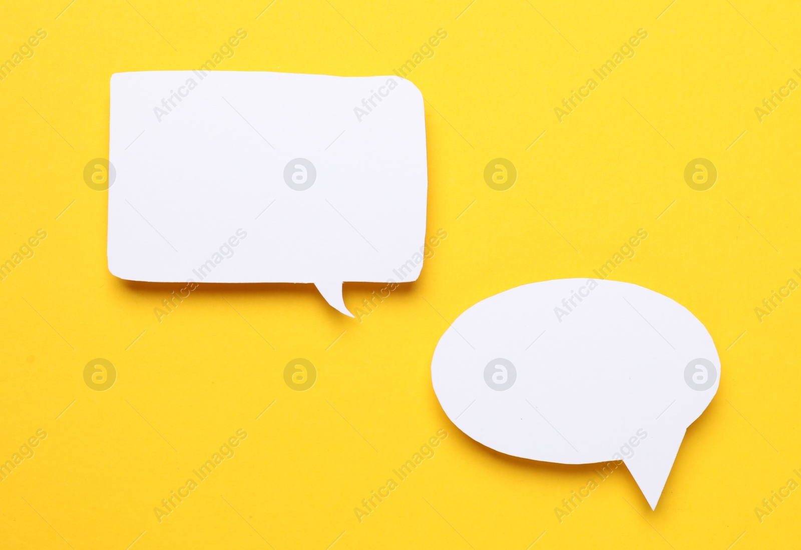 Photo of Blank speech bubbles on yellow background. Space for text