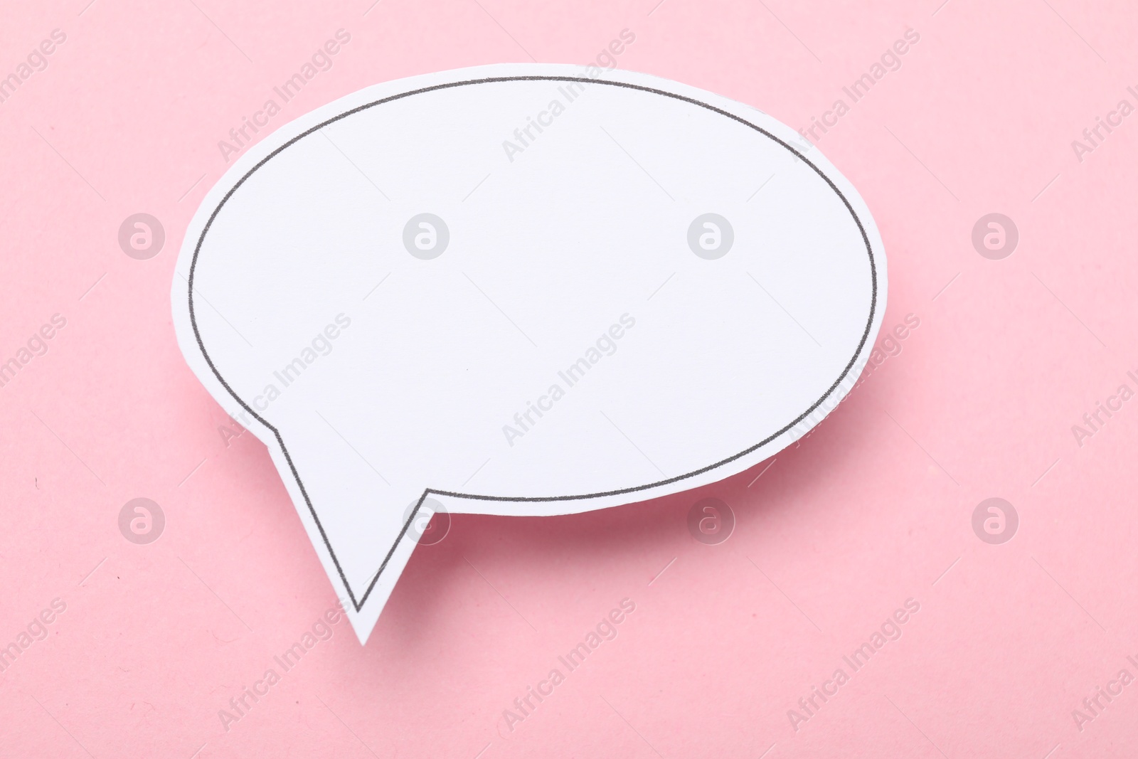 Photo of Blank speech bubble on light pink background. Space for text