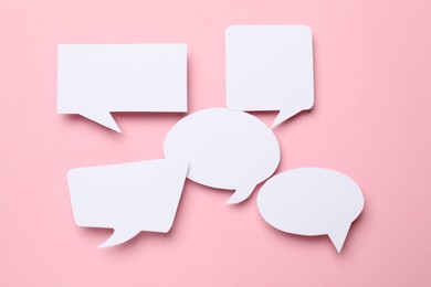 Photo of Blank speech bubbles on light pink background. Space for text