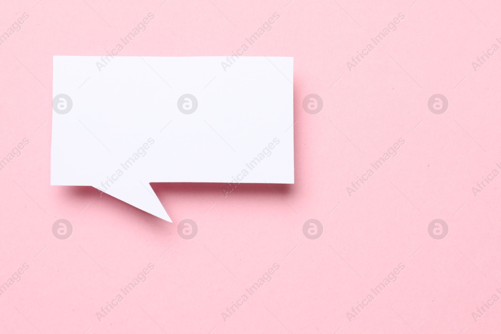 Photo of Blank speech bubble on light pink background. Space for text