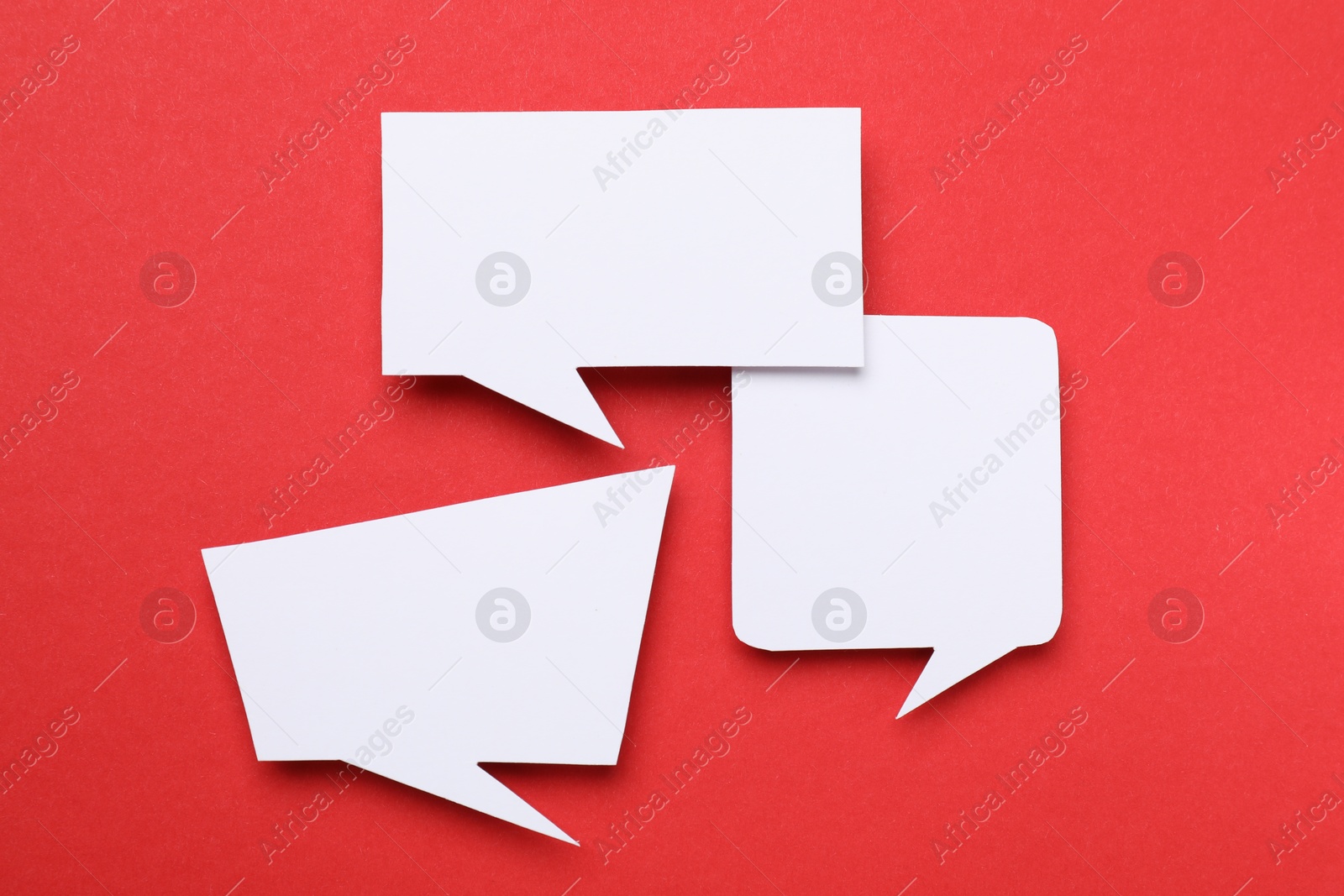 Photo of Blank speech bubbles on red background. Space for text