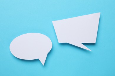 Photo of Blank speech bubbles on light blue background. Space for text