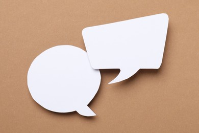 Photo of Blank speech bubbles on brown background. Space for text