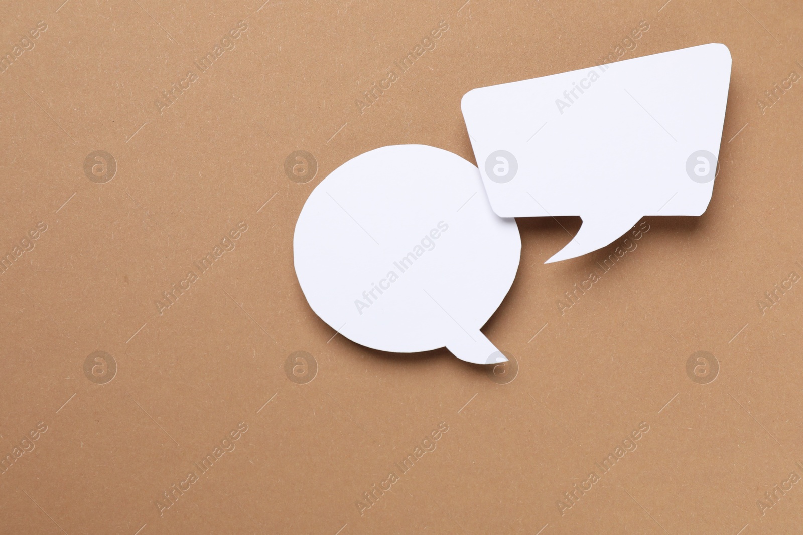 Photo of Blank speech bubbles on brown background. Space for text