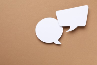 Photo of Blank speech bubbles on brown background. Space for text