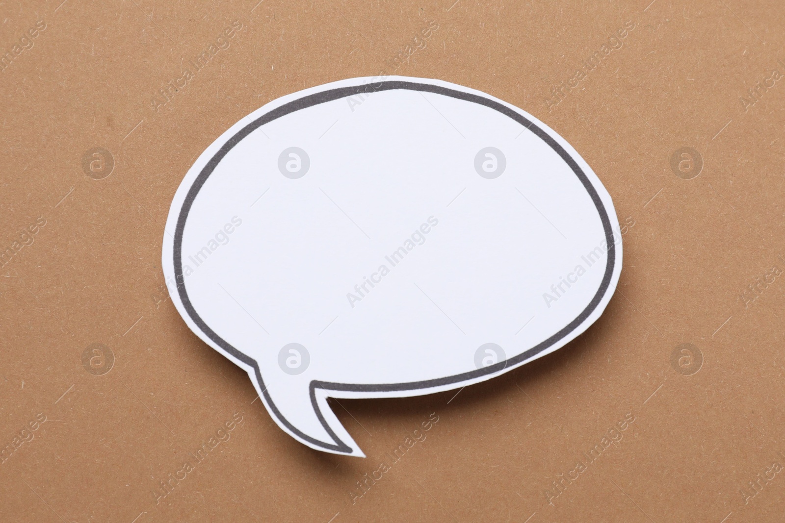 Photo of Blank speech bubble on brown background. Space for text