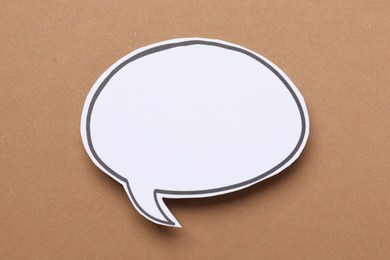 Photo of Blank speech bubble on brown background. Space for text