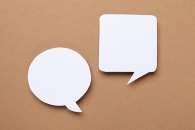 Photo of Blank speech bubbles on brown background. Space for text