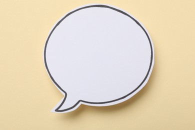 Photo of Blank speech bubble on beige background. Space for text