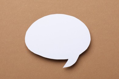 Photo of Blank speech bubble on brown background. Space for text