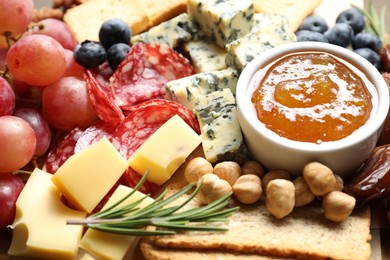 Photo of Different types of delicious cheese and other snacks as background, closeup