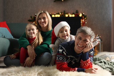 Photo of Lovely family near fireplace at home. Christmas season