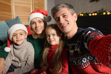 Photo of Lovely family taking selfie together at home. Christmas season