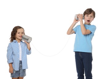 Photo of Boy and girl talking on tin can telephone against white background