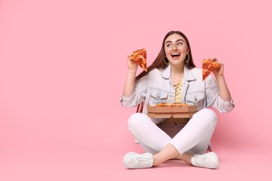 Beautiful woman with delicious pizza on pink background, space for text