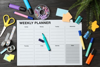 Timetable. Weekly planner and stationery on black wooden table, flat lay