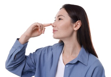 Photo of Young woman touching her nose on white background