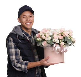 Photo of Smiling delivery man holding gift box with beautiful floral composition on white background