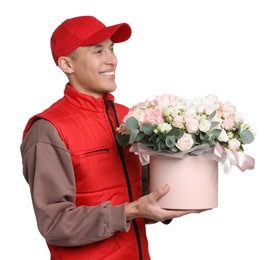 Smiling delivery man holding gift box with beautiful floral composition on white background