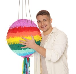 Photo of Happy man with colorful pinata on white background