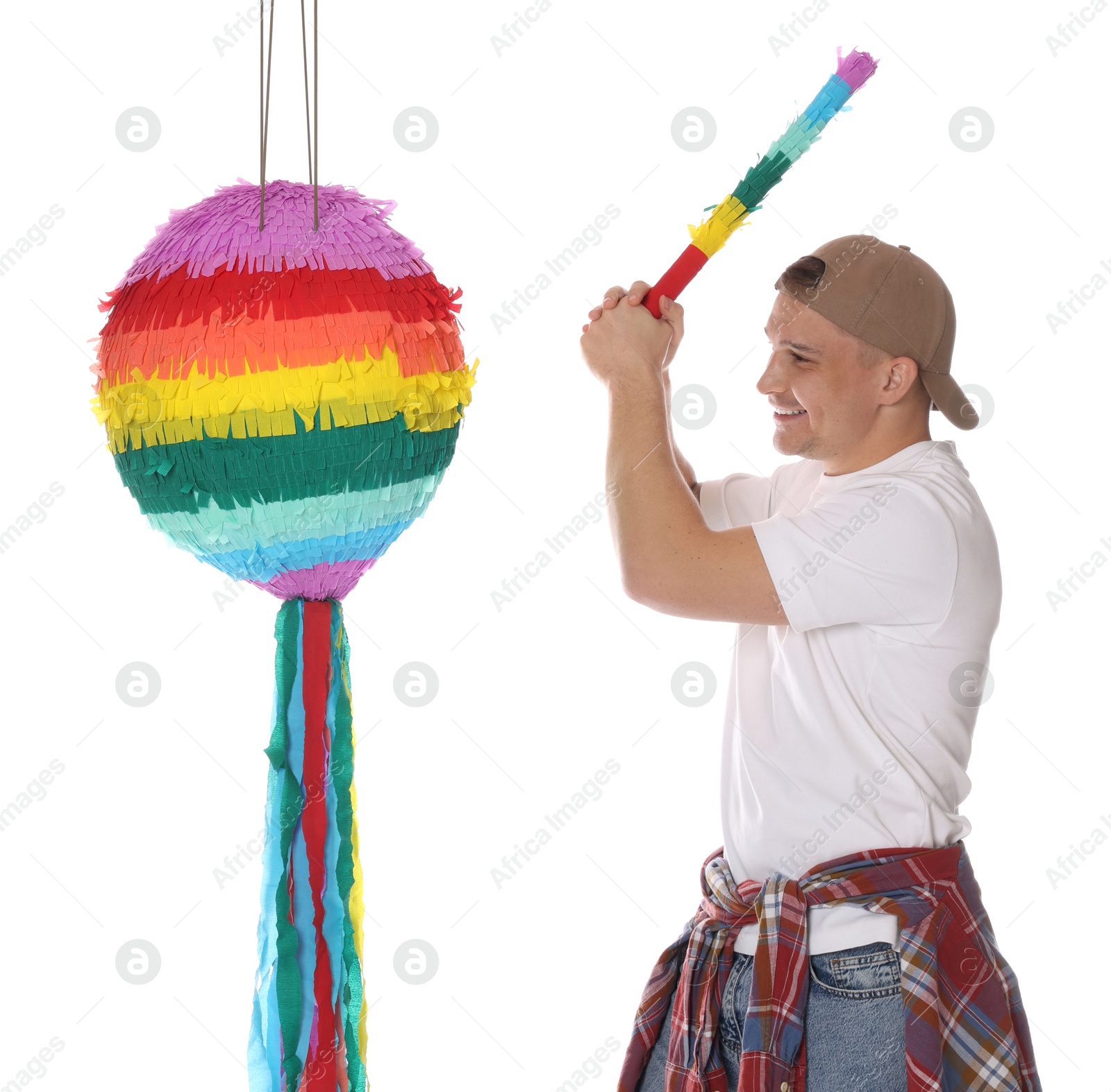 Photo of Happy man breaking pinata on white background