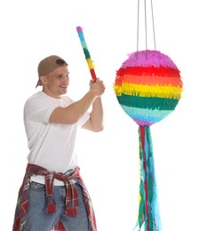 Photo of Happy man breaking pinata on white background